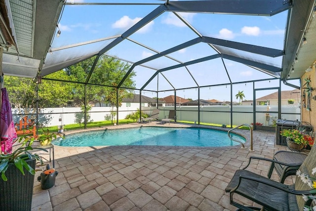 view of pool with a lanai and a patio