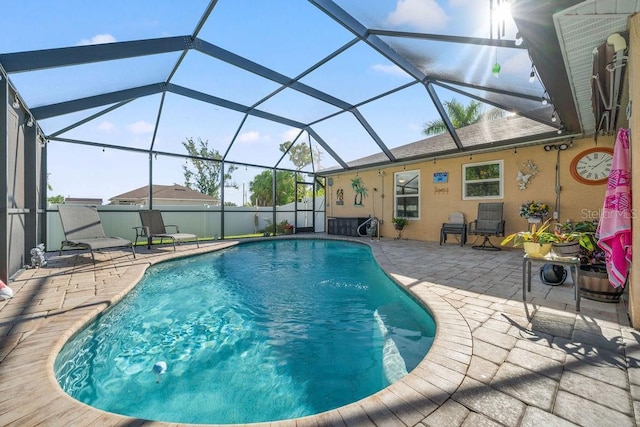 view of pool featuring a patio area and glass enclosure