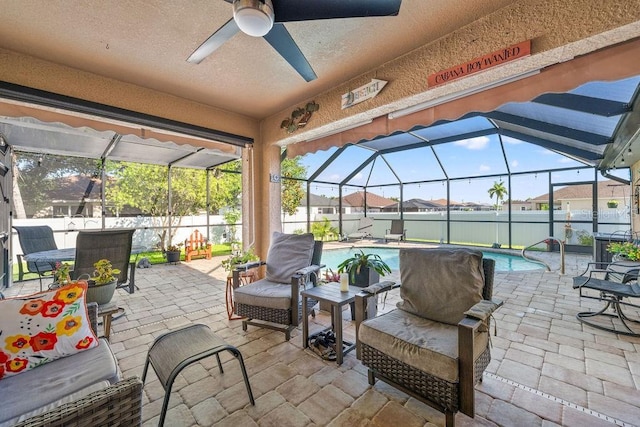 view of patio featuring a fenced in pool and glass enclosure