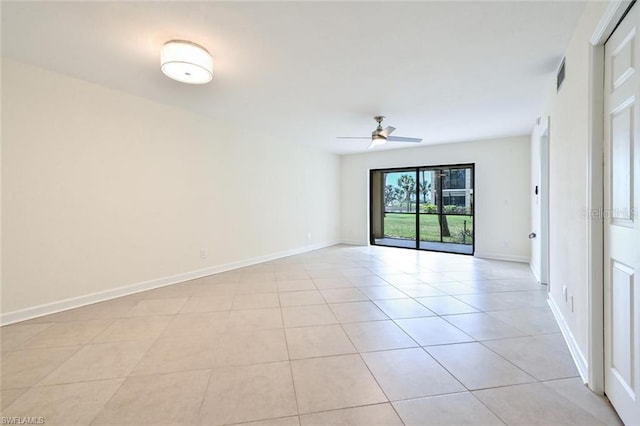 spare room featuring ceiling fan and light tile floors