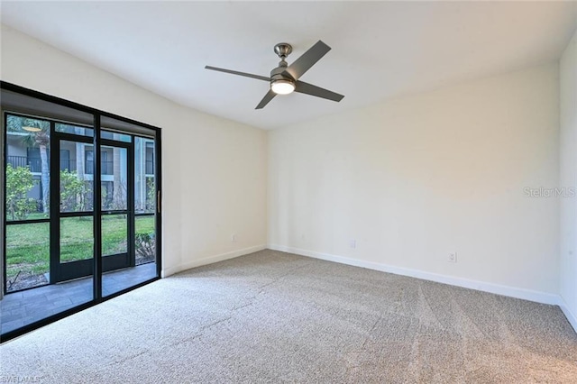 carpeted spare room with ceiling fan