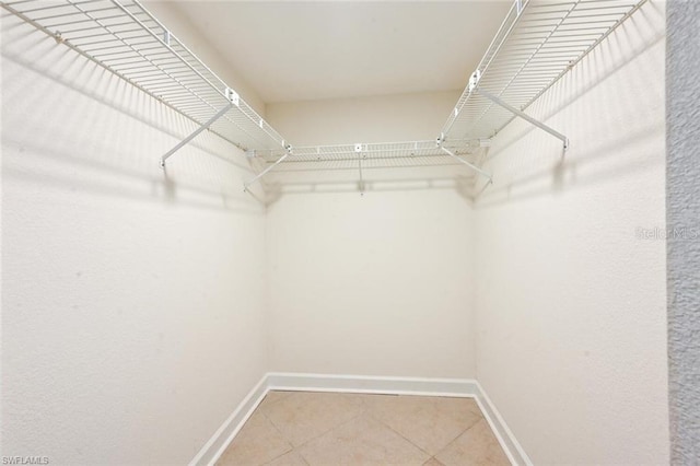 walk in closet featuring tile flooring