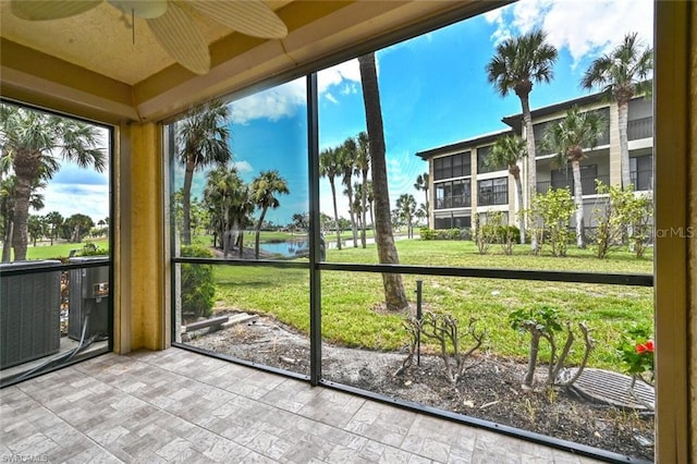 unfurnished sunroom featuring ceiling fan