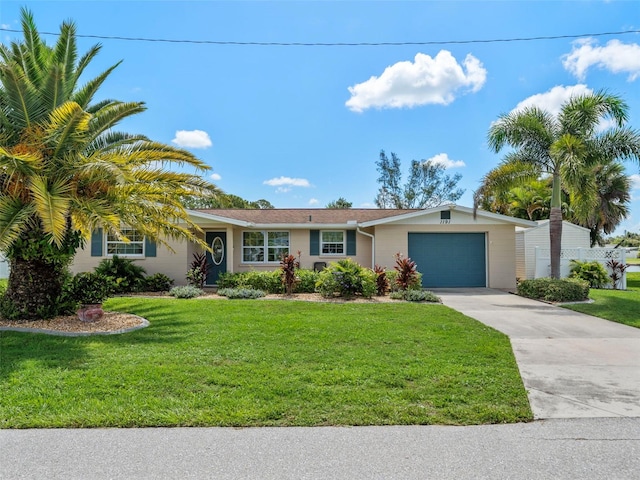 single story home featuring a garage and a front lawn