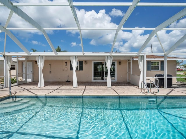 view of swimming pool with a patio, a lanai, and area for grilling