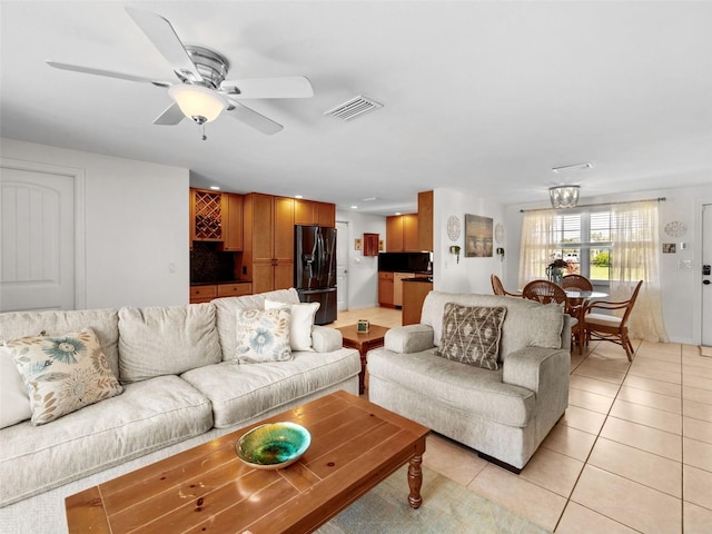 living room featuring light tile patterned flooring and ceiling fan