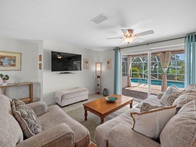 tiled living room featuring ceiling fan