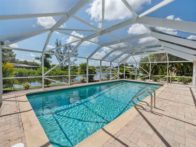 view of pool with a water view, a lanai, and a patio area