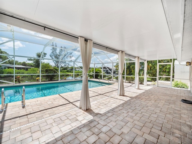 view of pool with a lanai and a patio