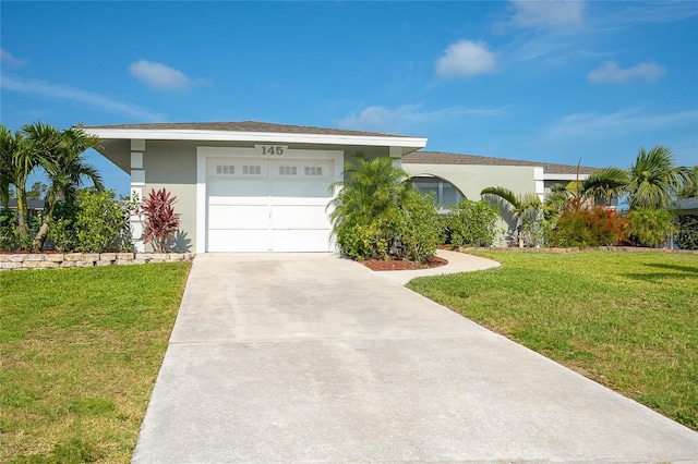 view of front facade with a garage and a front yard