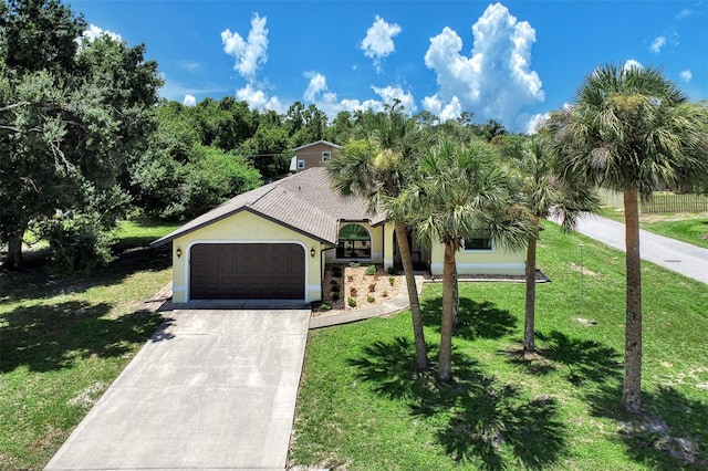 view of front of property featuring a garage and a front yard