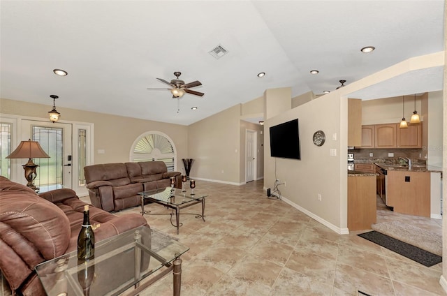 tiled living room with sink and ceiling fan