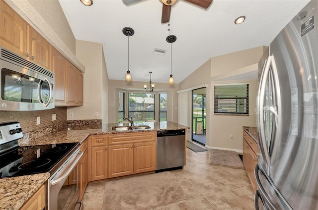 kitchen featuring tasteful backsplash, hanging light fixtures, sink, appliances with stainless steel finishes, and light tile patterned floors