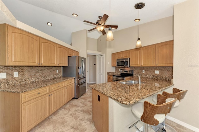 kitchen featuring light tile patterned floors, stone countertops, tasteful backsplash, and stainless steel appliances