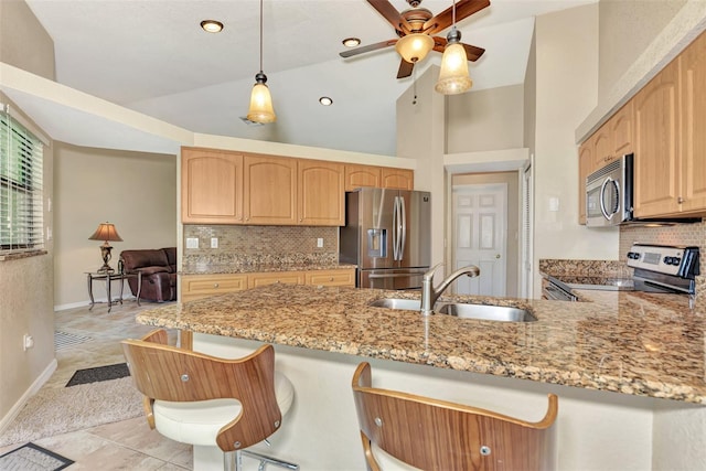 kitchen featuring appliances with stainless steel finishes, high vaulted ceiling, and backsplash