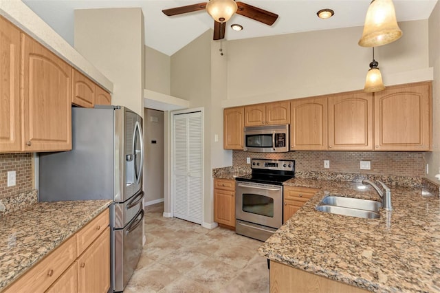 kitchen with backsplash, light stone counters, hanging light fixtures, appliances with stainless steel finishes, and sink