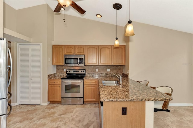 kitchen featuring stone counters, appliances with stainless steel finishes, light tile patterned flooring, and sink