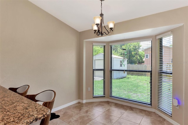 tiled home office featuring an inviting chandelier, lofted ceiling, and a wealth of natural light