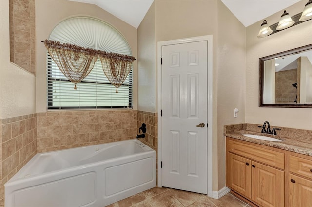 bathroom featuring vaulted ceiling, vanity, tile patterned flooring, and a bath