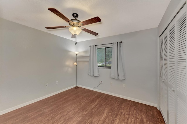 unfurnished bedroom with hardwood / wood-style flooring, a closet, and ceiling fan