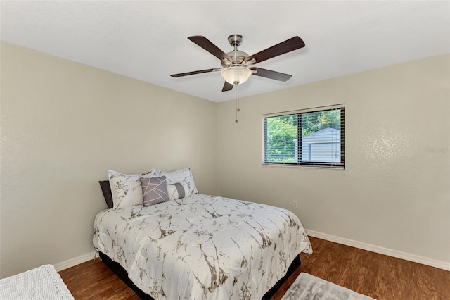 bedroom featuring ceiling fan and dark hardwood / wood-style floors