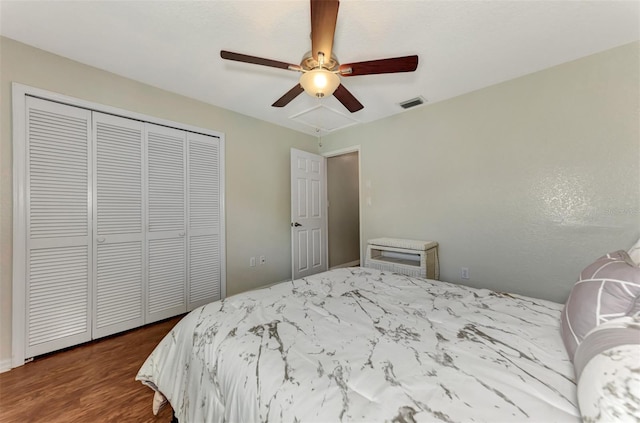 bedroom with a closet, ceiling fan, and hardwood / wood-style floors