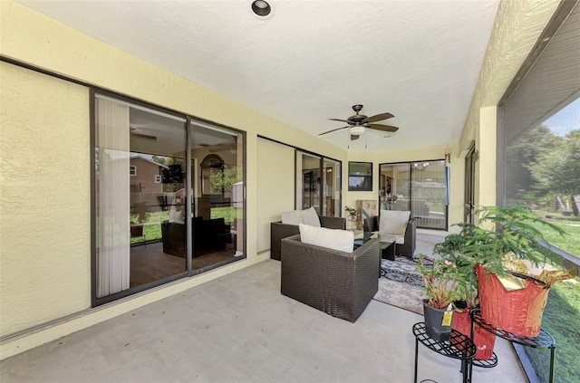 sunroom / solarium featuring ceiling fan