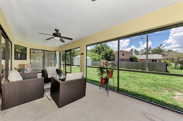 sunroom / solarium featuring ceiling fan