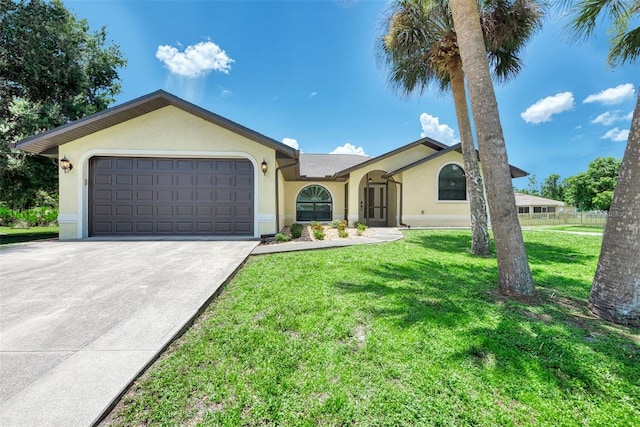 ranch-style home featuring a garage and a front lawn