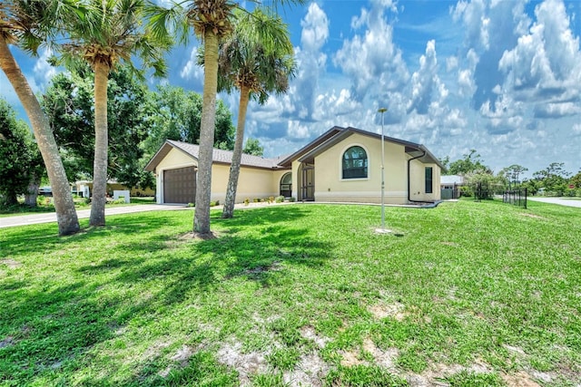 ranch-style home featuring a garage and a front lawn