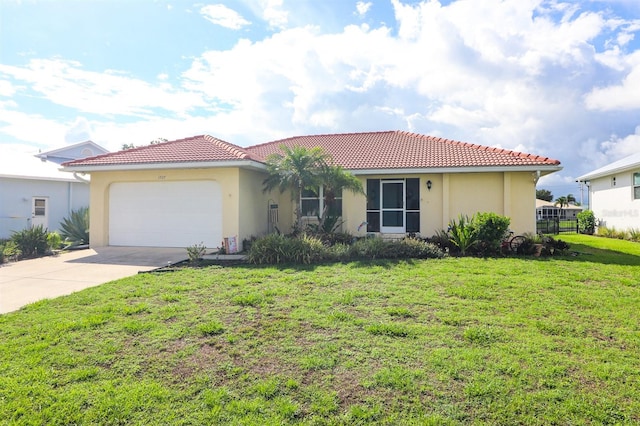 mediterranean / spanish home with a front yard and a garage