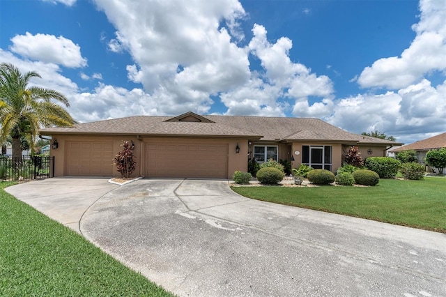 single story home featuring a garage and a front yard