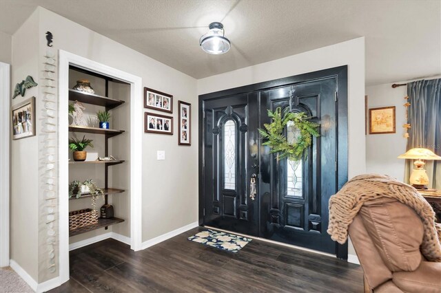 entrance foyer with a textured ceiling and hardwood / wood-style floors