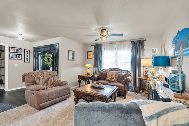 living room featuring ceiling fan, hardwood / wood-style floors, and a textured ceiling