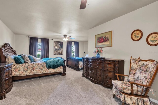 bedroom featuring ceiling fan and carpet