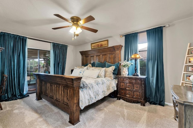 bedroom featuring access to outside, light colored carpet, and ceiling fan