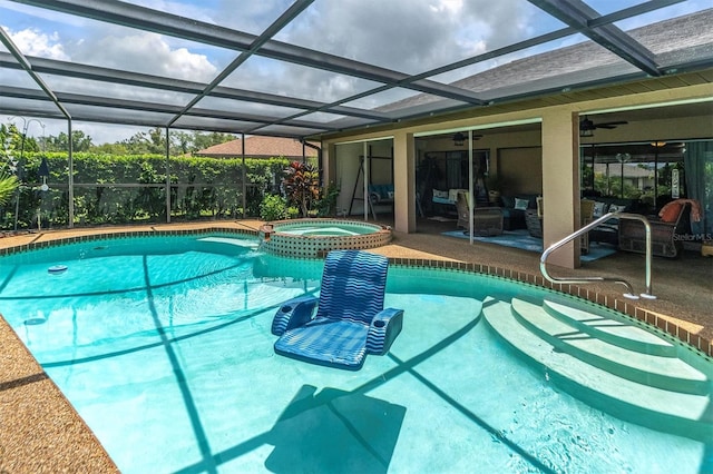 view of swimming pool featuring an in ground hot tub, ceiling fan, glass enclosure, and a patio area