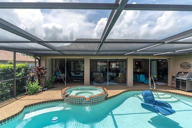 view of pool featuring grilling area, an in ground hot tub, glass enclosure, and a patio