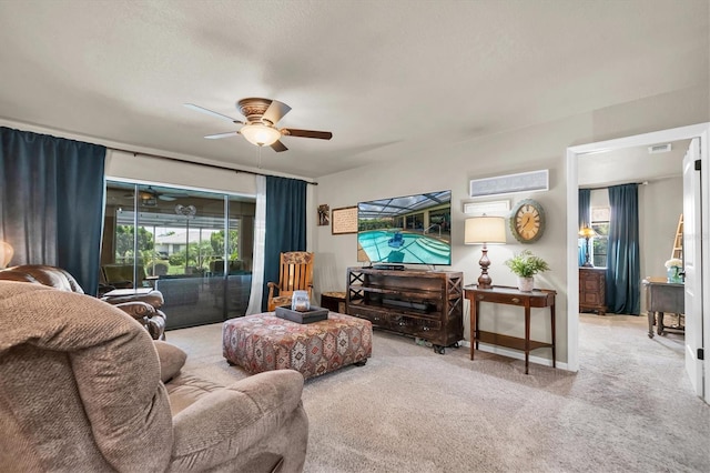 carpeted living room featuring a ceiling fan and visible vents