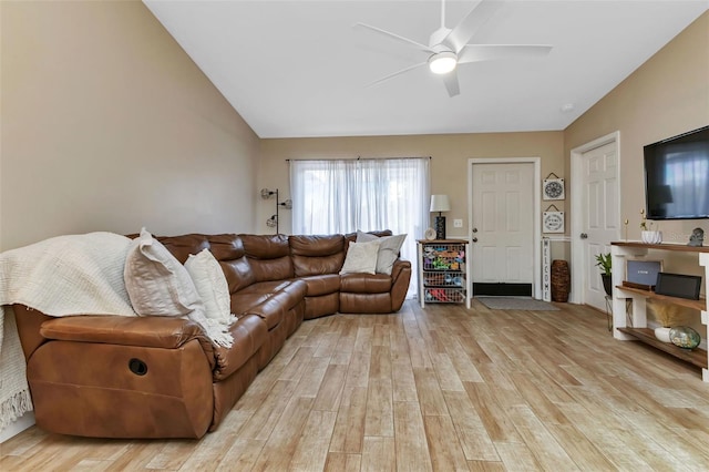 living room featuring ceiling fan, light hardwood / wood-style floors, and lofted ceiling