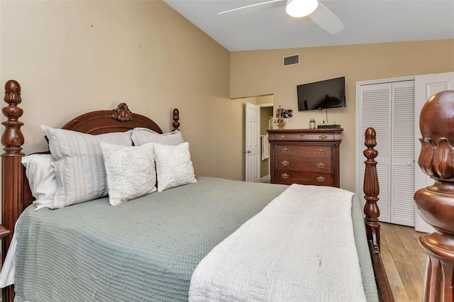 bedroom featuring a closet, vaulted ceiling, ceiling fan, and light hardwood / wood-style flooring