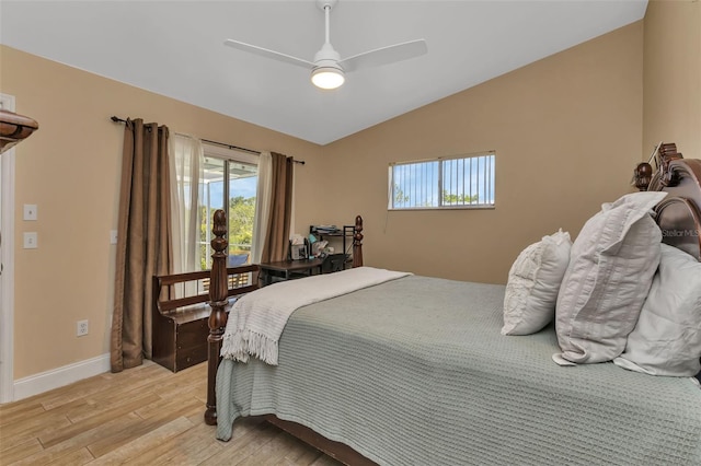 bedroom with ceiling fan, vaulted ceiling, and light hardwood / wood-style flooring