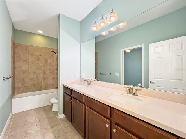 full bathroom featuring tile patterned floors, vanity, toilet, and tiled shower / bath combo