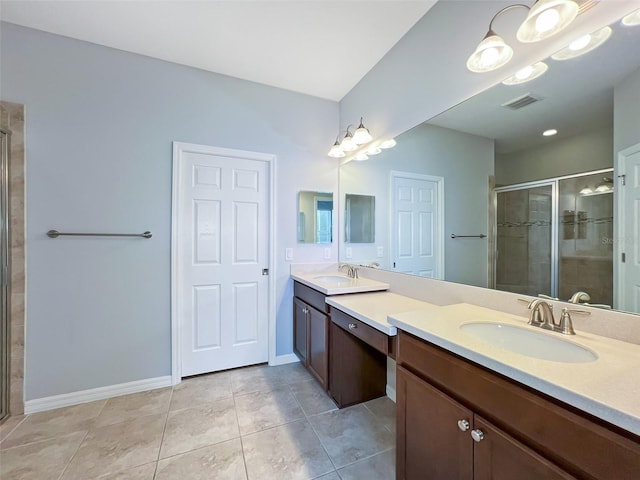 bathroom featuring tile patterned flooring, vanity, an inviting chandelier, and an enclosed shower