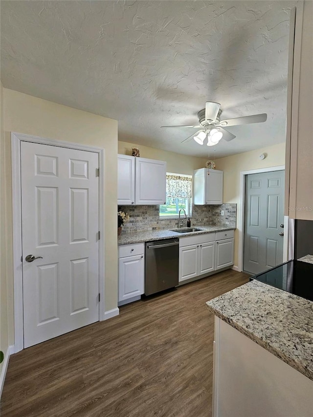 kitchen featuring dishwasher, dark wood-type flooring, white cabinets, sink, and tasteful backsplash