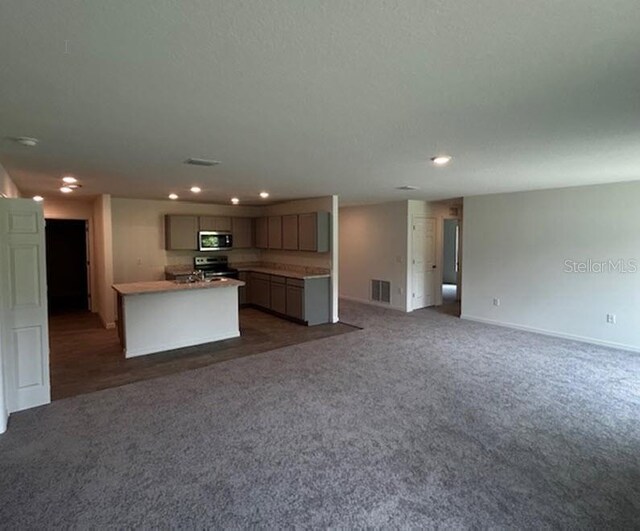 unfurnished living room featuring dark carpet