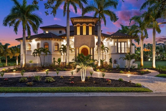 mediterranean / spanish house featuring stucco siding and driveway