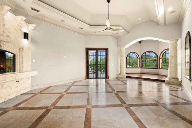 unfurnished living room with beamed ceiling, decorative columns, tile patterned flooring, french doors, and ceiling fan