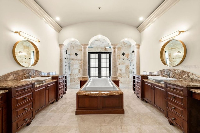 bathroom with french doors, ornate columns, tile patterned floors, shower with separate bathtub, and double sink vanity