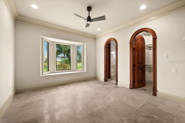 unfurnished room with a ceiling fan, baseboards, and ornamental molding